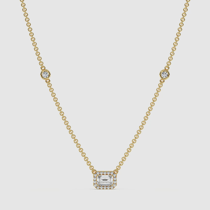 Video showcasing the Elegant Emerald Diamond Bezel Station Necklace in 18K Yellow Gold