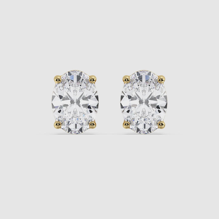 Video showcasing Elegant Oval Shaped Lab-Created Diamond Stud Earrings in Yellow Gold. Featuring close-up views of the dazzling EF/VS lab-grown diamonds set in luxurious 18K yellow gold. Perfect for any occasion, highlighting their elegant design and brilliant sparkle.