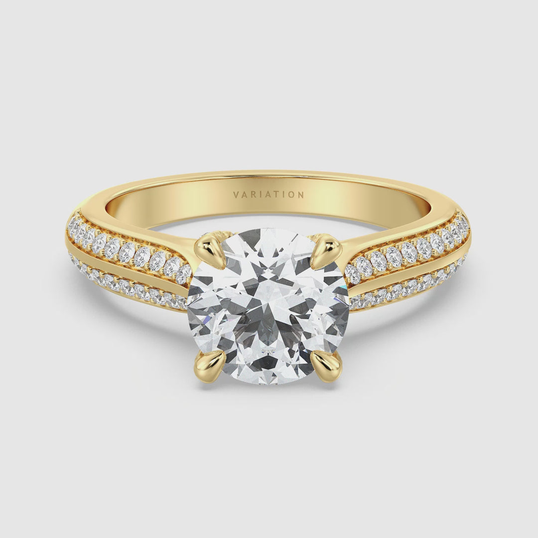 Video showcasing the Round-Cut Lab Grown Diamond Engagement Ring with Pavé Band in 18K Yellow Gold. The video highlights the 4-claw prong setting, sparkling 1ct to 4ct center diamond, and 0.44ct of side diamonds set along the pavé band, providing a detailed view of the elegant design from various angles.