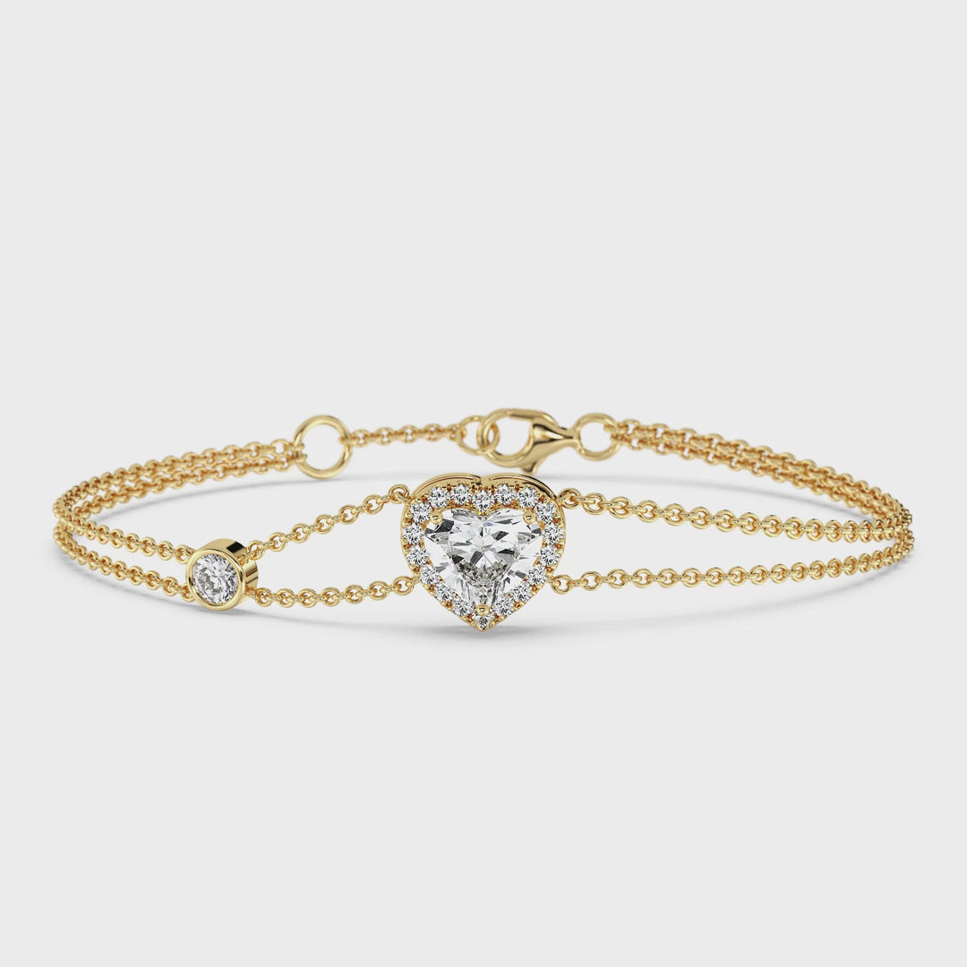 Video showcasing the Double Chain Bracelet in 18K Yellow Gold, featuring a 1ct heart-cut lab-grown diamond in a dazzling halo setting with 19 round EF/VS lab diamonds, totaling 1.43ct.