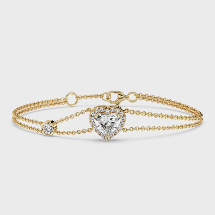 Video showcasing the Double Chain Bracelet in 18K Yellow Gold, featuring a 1ct heart-cut lab-grown diamond in a dazzling halo setting with 19 round EF/VS lab diamonds, totaling 1.43ct.