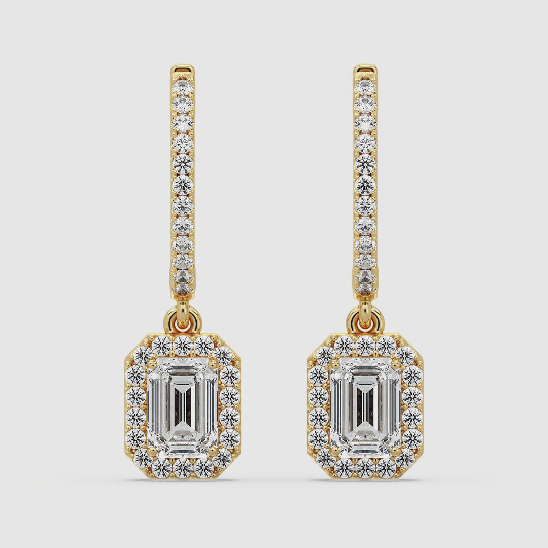 Video showcasing Elegant Emerald Cut Lab-Grown Diamond Minimalist Halo Hoop Earrings in Yellow Gold, highlighting the sparkle of 3.90 carats of lab-grown diamonds set in luxurious 18K gold. Watch as the exquisite emerald cut and round cut diamonds dazzle from every angle, perfect for any occasion.