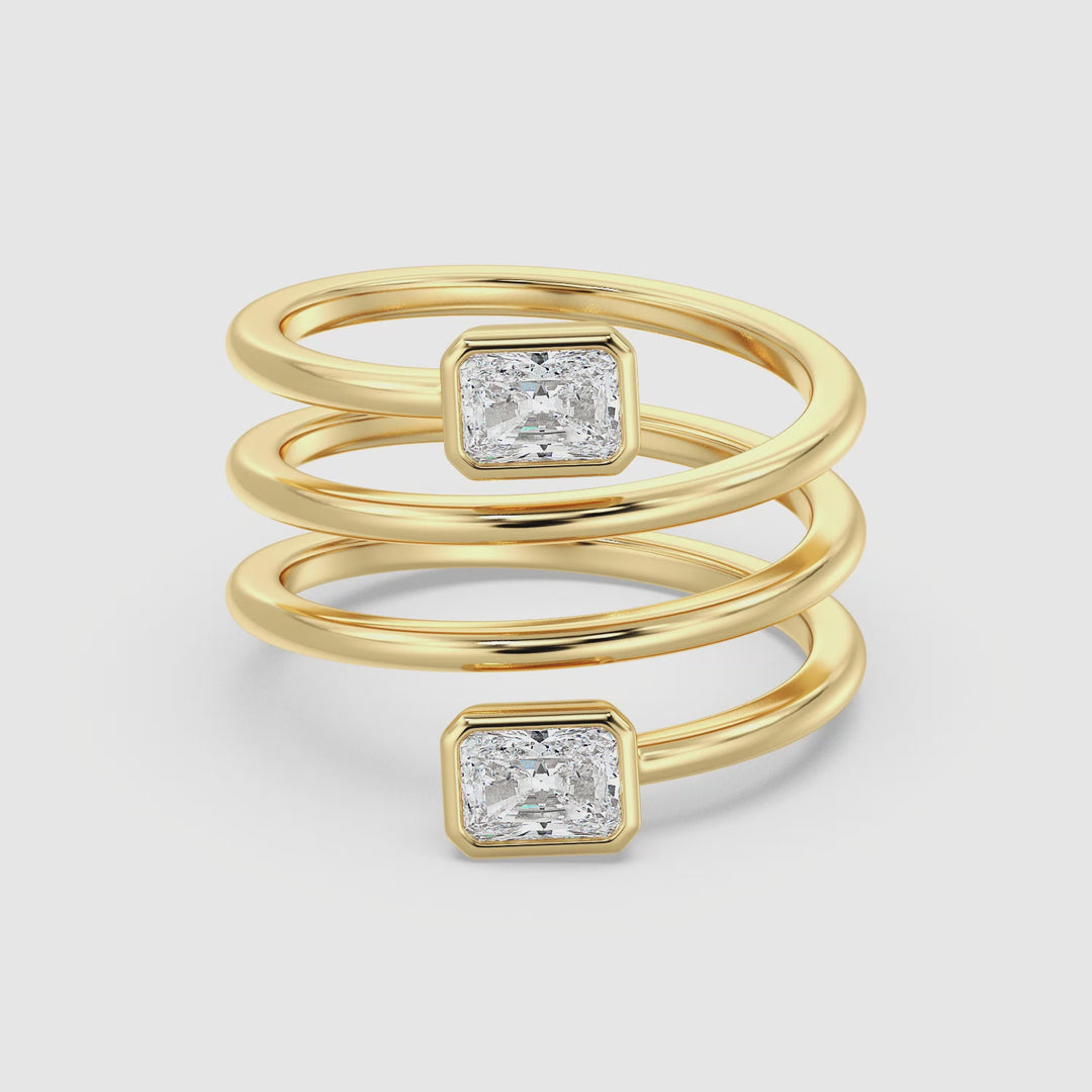 360° view of the Radiant-Cut Dual Stone Lab-Grown Diamond Spiral Statement Ring in 18K Yellow Gold with Bezel Setting, showcasing the brilliance of the two radiant-cut diamonds in a modern spiral design