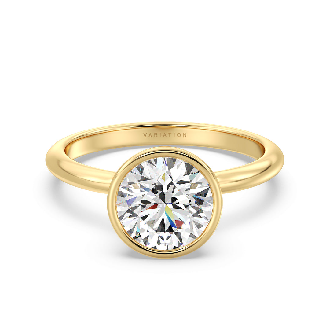 Elegant round brilliant cut lab grown diamond bezel engagement ring crafted in 18K yellow gold with a sleek contemporary design.