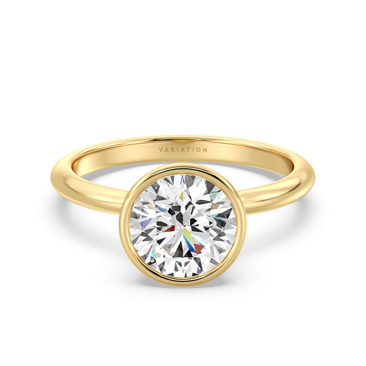 Elegant round brilliant cut lab grown diamond bezel engagement ring crafted in 18K yellow gold with a sleek contemporary design.