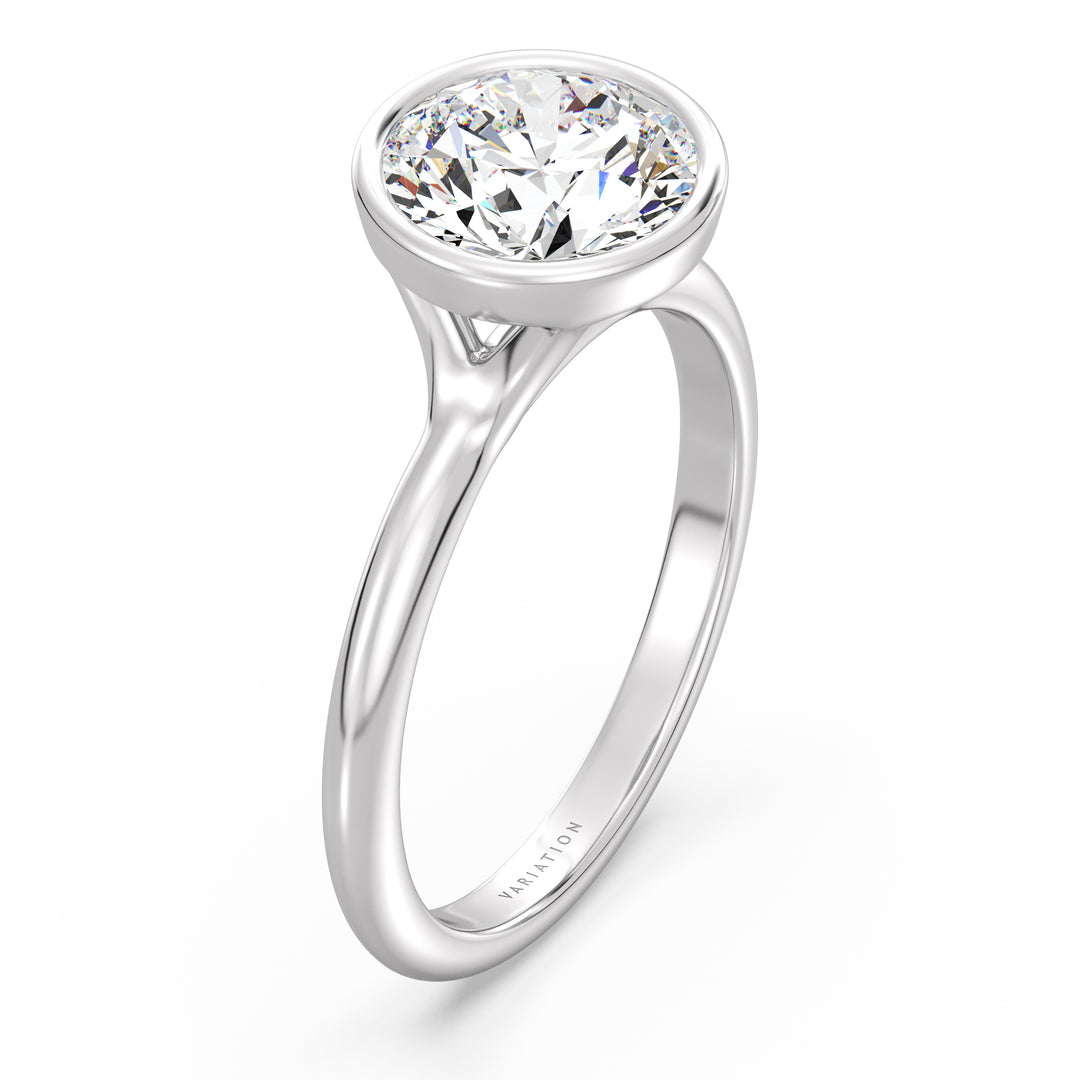 Round brilliant cut lab grown diamond bezel solitaire ring in 18K white gold with an IGI certified diamond and sleek modern bezel design.