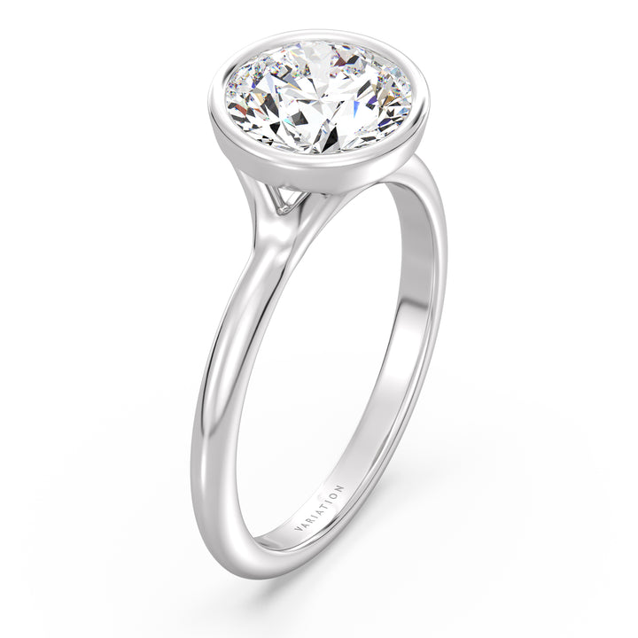 Round brilliant cut lab grown diamond bezel solitaire ring in 18K white gold with an IGI certified diamond and sleek modern bezel design.