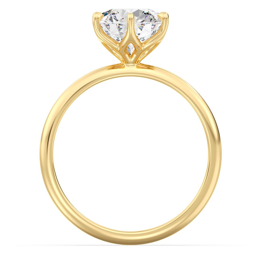 Round brilliant cut lab grown diamond ring in 18K yellow gold showcasing maximum brilliance and an open basket setting.