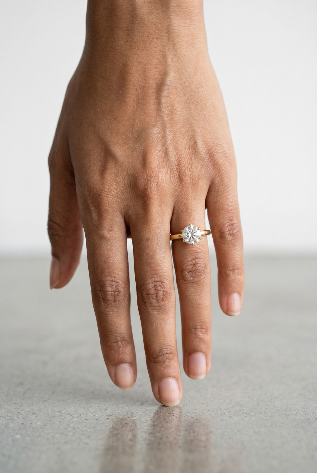 Elegant round brilliant cut lab grown diamond solitaire ring crafted in 18K yellow gold with exceptional sparkle and timeless sophistication.