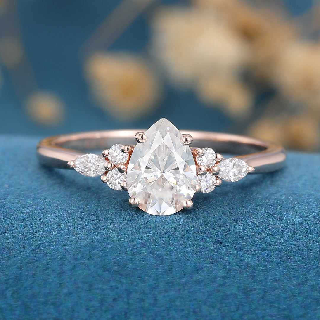 A captivating 1.0 CT pear-shaped Moissanite cluster engagement ring